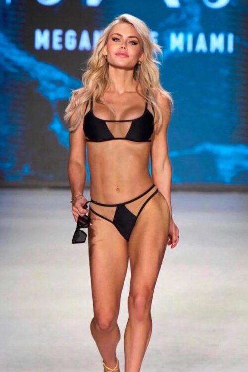 a model walking the catwalk in a black mesh bikini