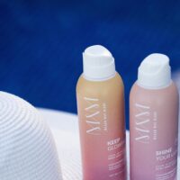 two bottles of Keep Glowing and Shine Your Light Body Sunscreen