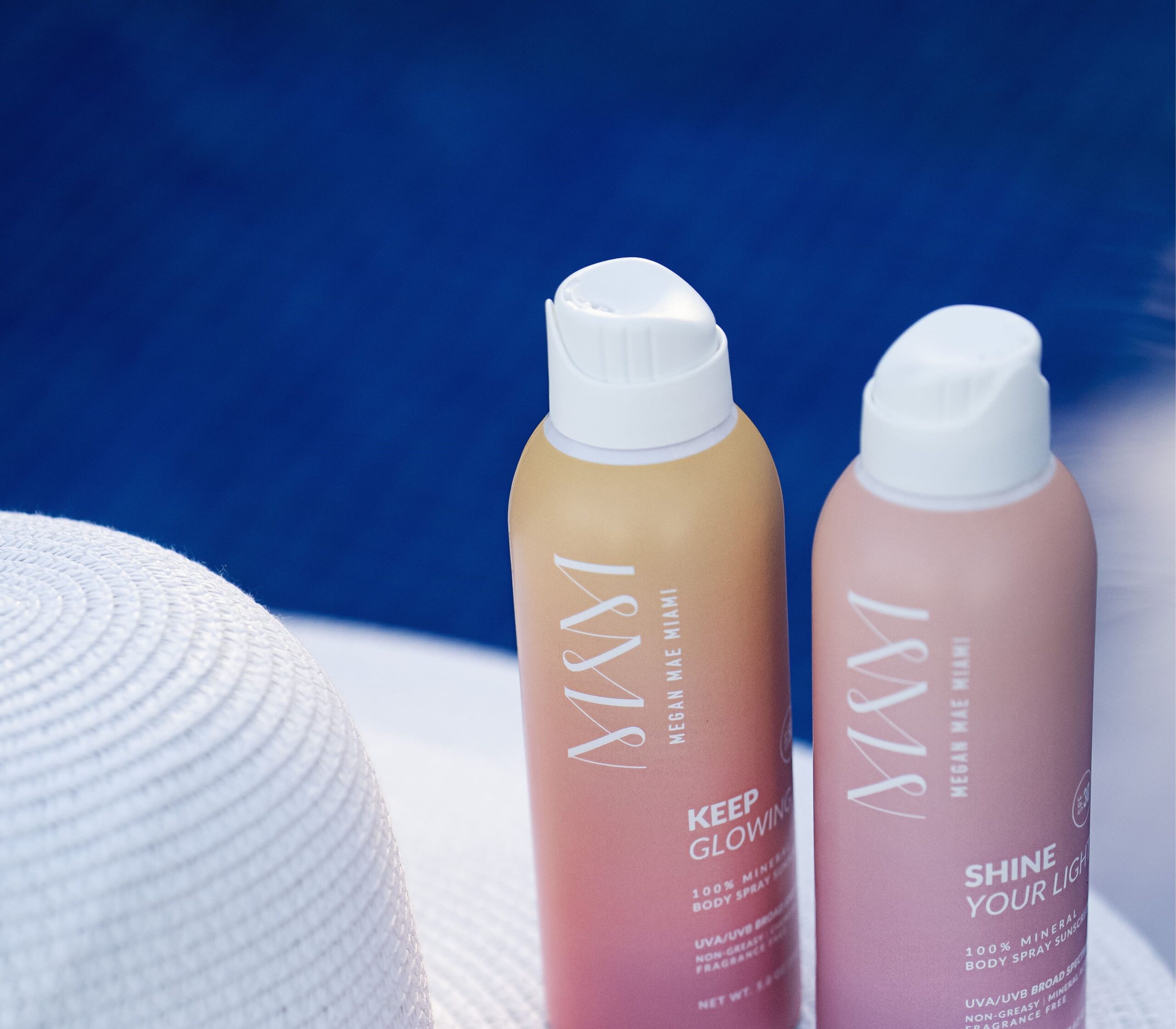 two bottles of Keep Glowing and Shine Your Light Body Sunscreen