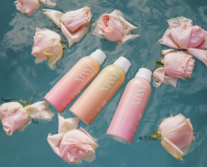 suncare products floating in a pool with roses